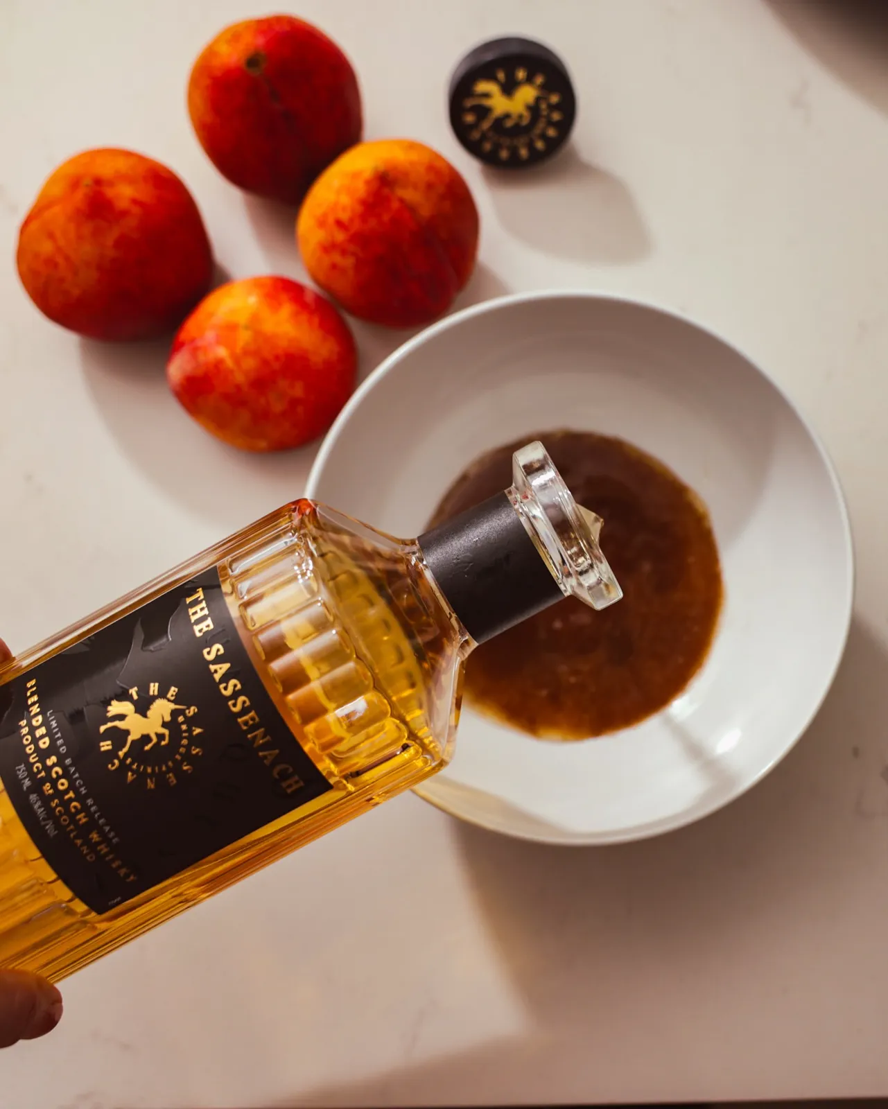 Pouring Sassenach Whisky for the peach glaze