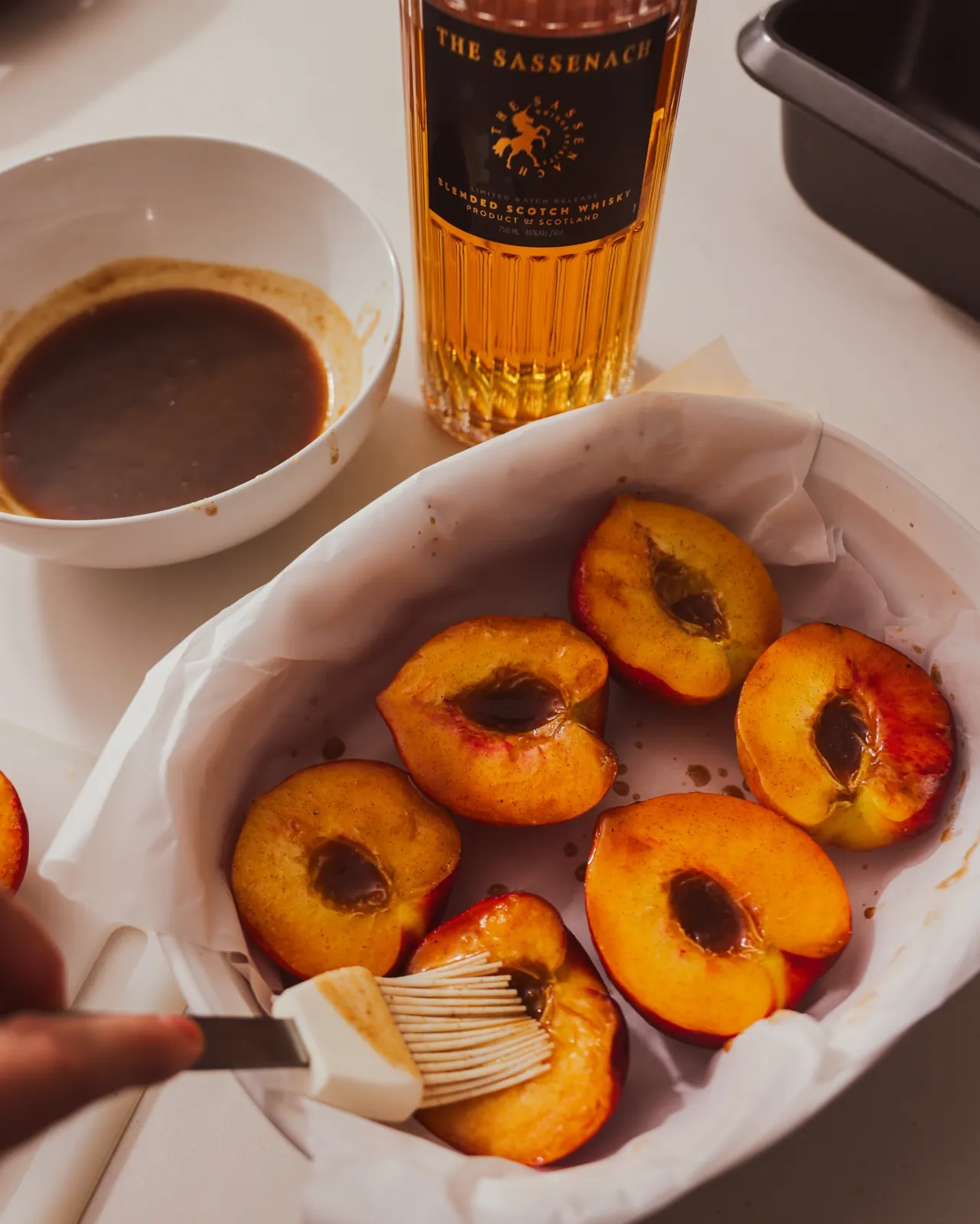 Brushing the whisky mixture over the cut sides of the peaches