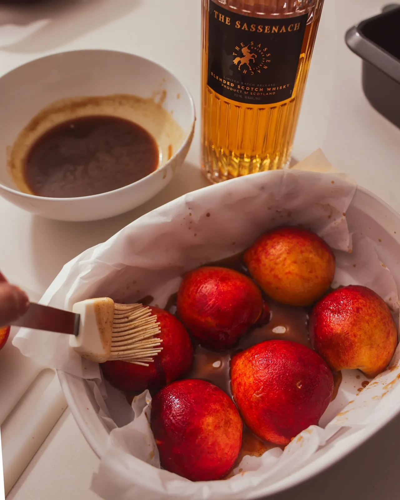 Brushing the whisky mixture over the backs of the peaches