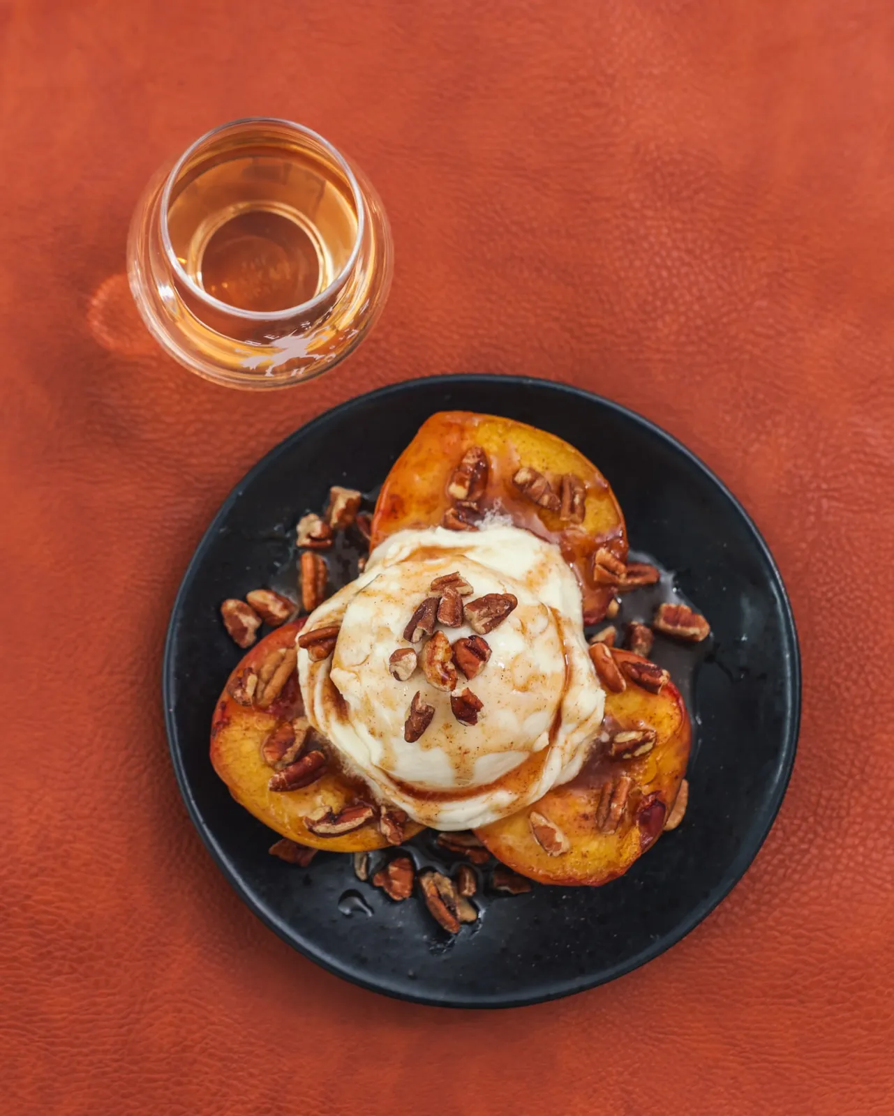 Whisky roasted peaches served with vanilla ice cream and pecans